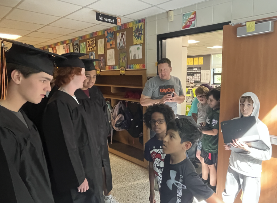 Graduate Teddy Dahlin Interacts with the students at Susan Lindgren May 31. The seniors commemorated their graduation by holding a senior walk through elementary schools Wednesday.