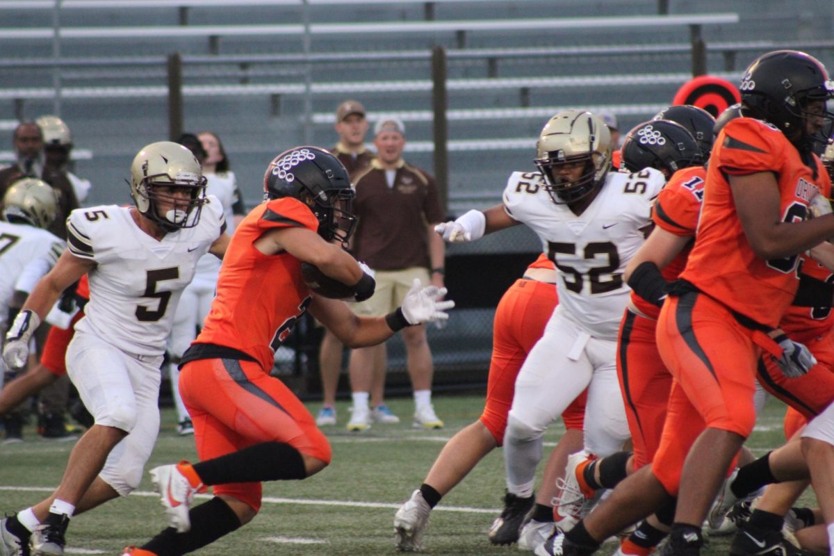 Helfmann receives a handoff from Rickord achieving another first down for the Orioles Sept. 14. Park walks away with a loss against Apple Valley 7-31.
