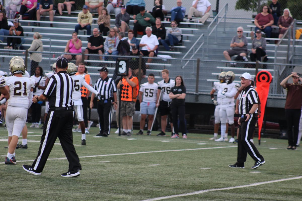 Referees talking after a play Sep. 14. Park played on a Thursday due to recent referee shortages.