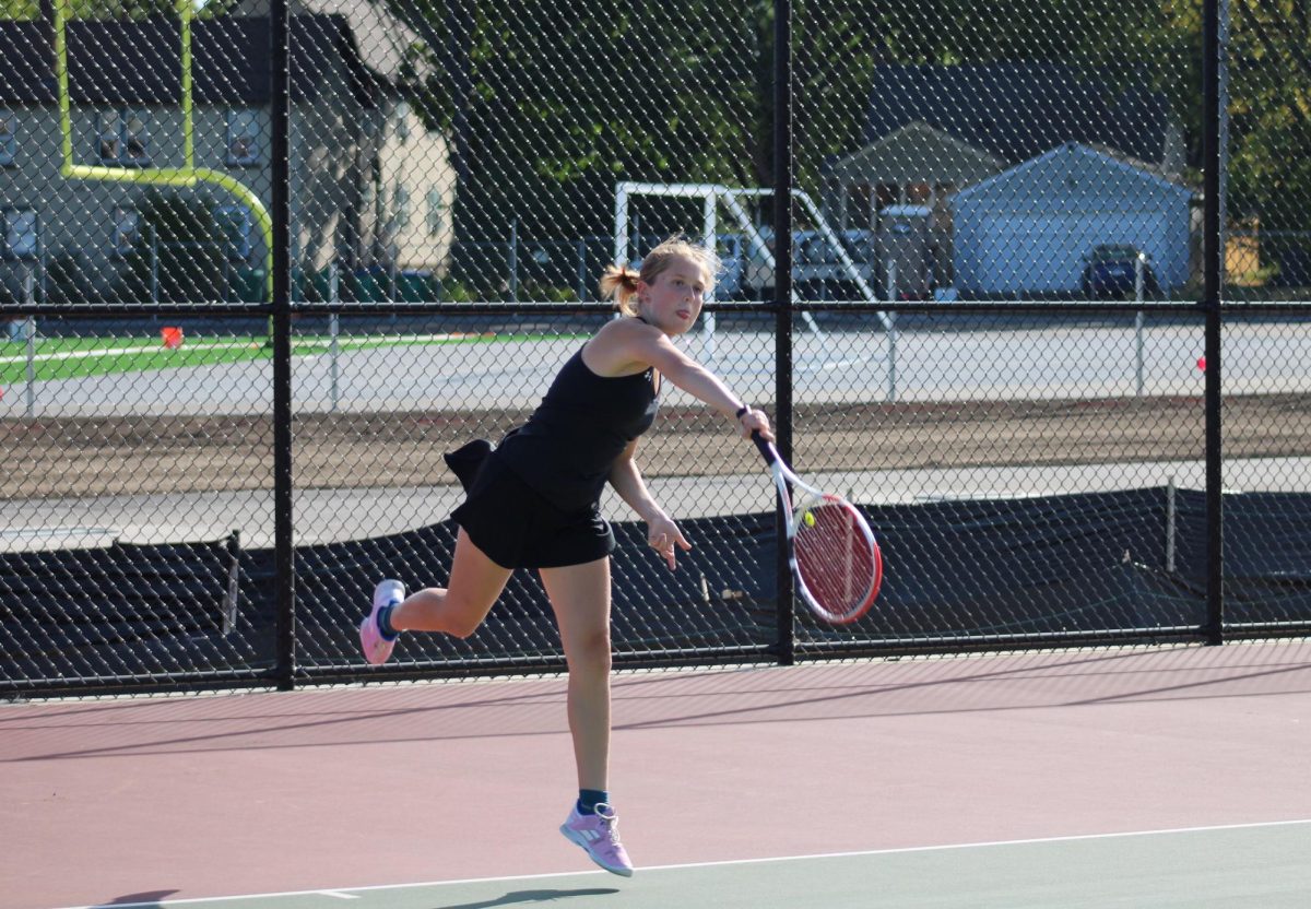 Alison Garland serves to her opponent on Sept. 14. Garland forfeited the match due to injury.