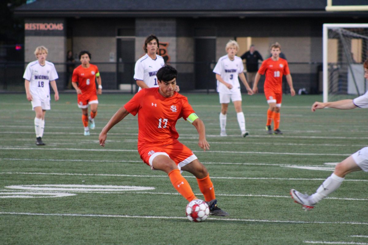 Senior+Raul+Sanchez+Sandoval+cuts+the+ball+past+the+Waconia+defender+Sept.+20.+Park%E2%80%99s+boys+soccer+wins+the+game+with+a+4-2+win+against+Waconia.