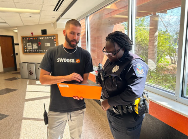 Juvenile response officer Stanikka Alacantara and Chris Nordstrom  examine a computer Sept. 19. The school is implementing a new policy that limits the presence of resource officers in school.