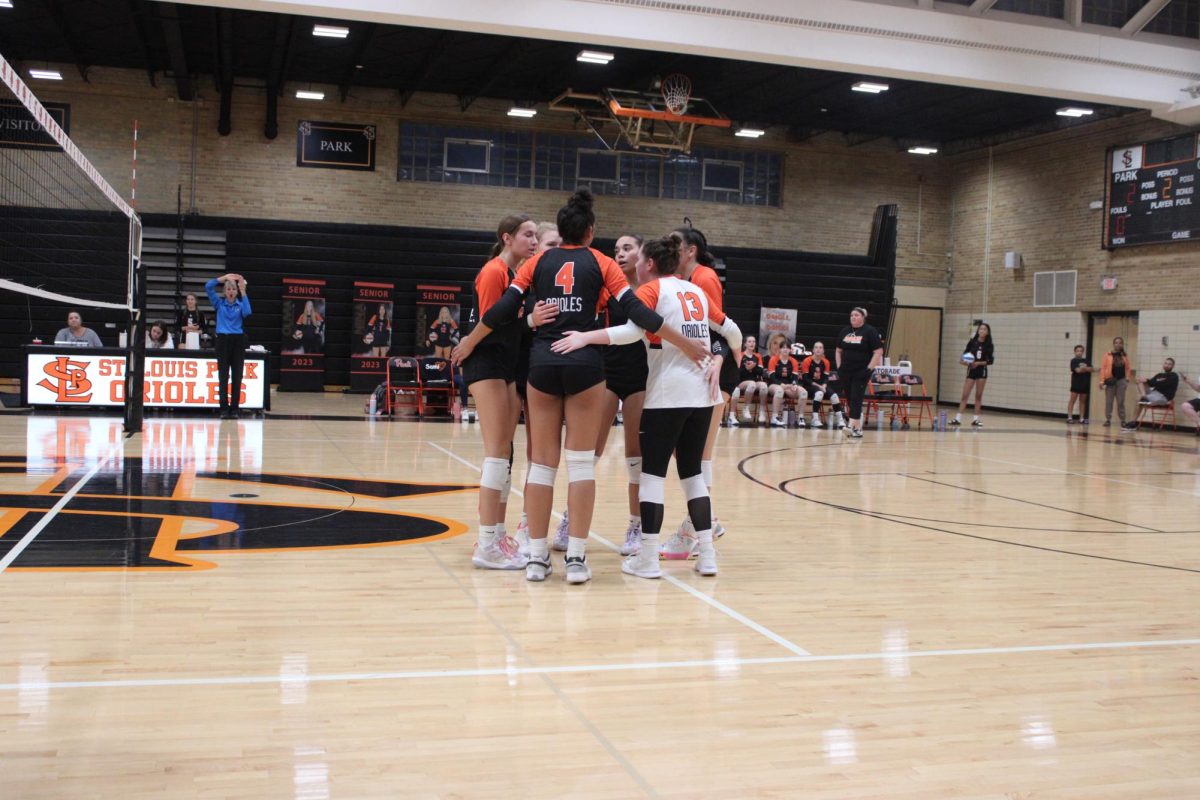 The Orioles huddled together after a point Sept. 28. They prepare to mount a comeback against New Prague.