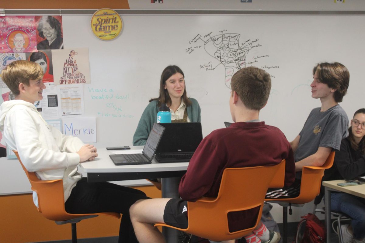 Senior Chiara Collinet having a discussion with classmates in IB History of the Americas Nov. 21. The class satisfies one of the requirements on her path to the IB diploma.