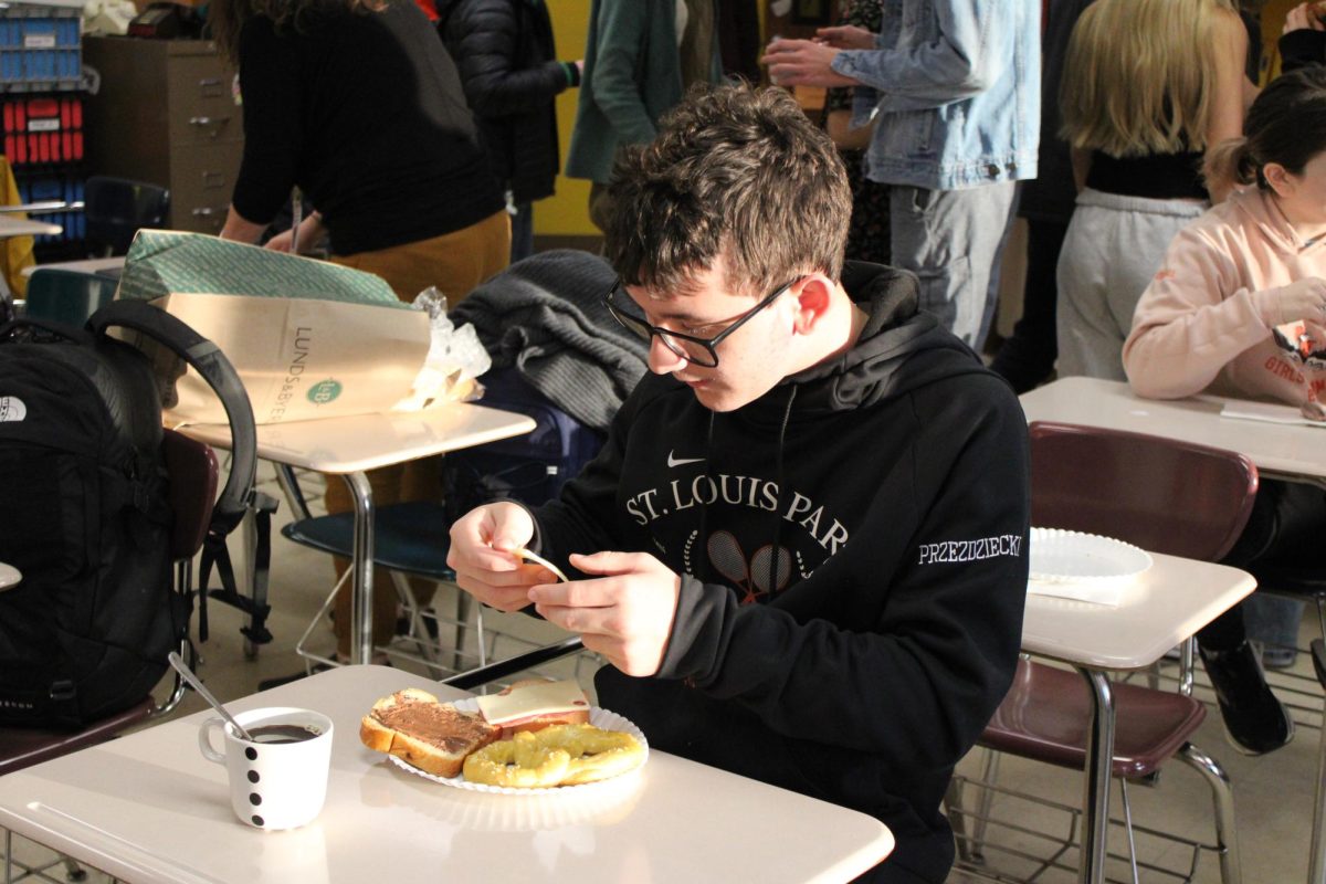 Junior Max Przezdziecki enjoys a German-style breakfast at the German and French class breakfast. They had traditional German food for students to enjoy Nov. 16. 