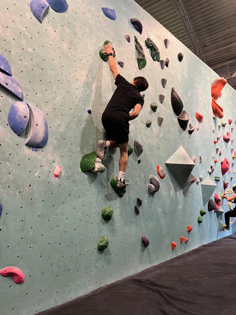 Junior Lucas Tangelson climbs rockwall on Nov. 24. Rock Climbing club meets Friday mornings.