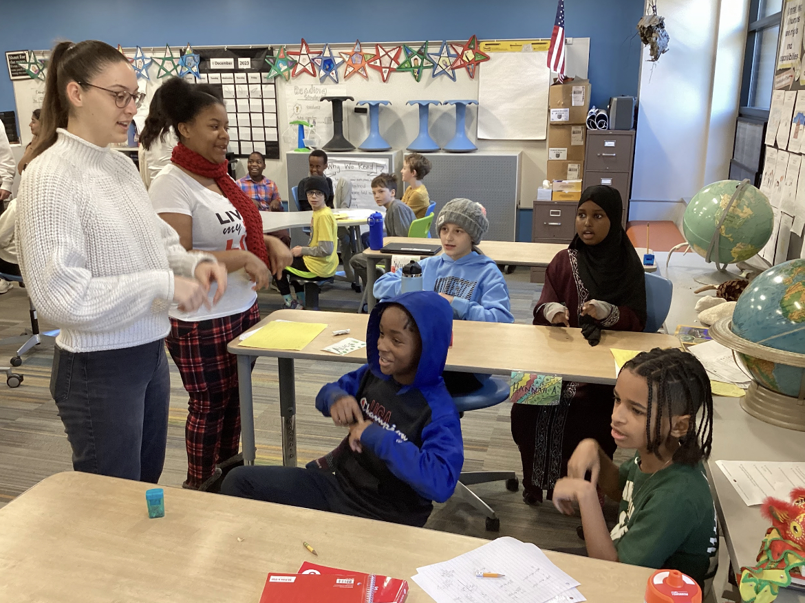 Photo used with permission from Sheri Fox: Senior Annika Koelz and junior Sy’Mora Blue teach students a German dance Dec 7. Students from Park went to Susan Lindgren to teach the students what a traditional Christmas looks like in Germany. 