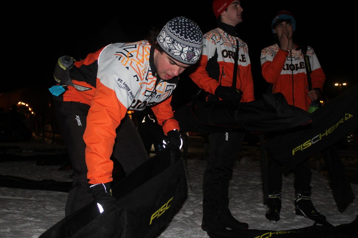 Senior Tommy Walsh packs his skis into his bag Dec. 12. The nordic team practices at Theodore Wirth Park.