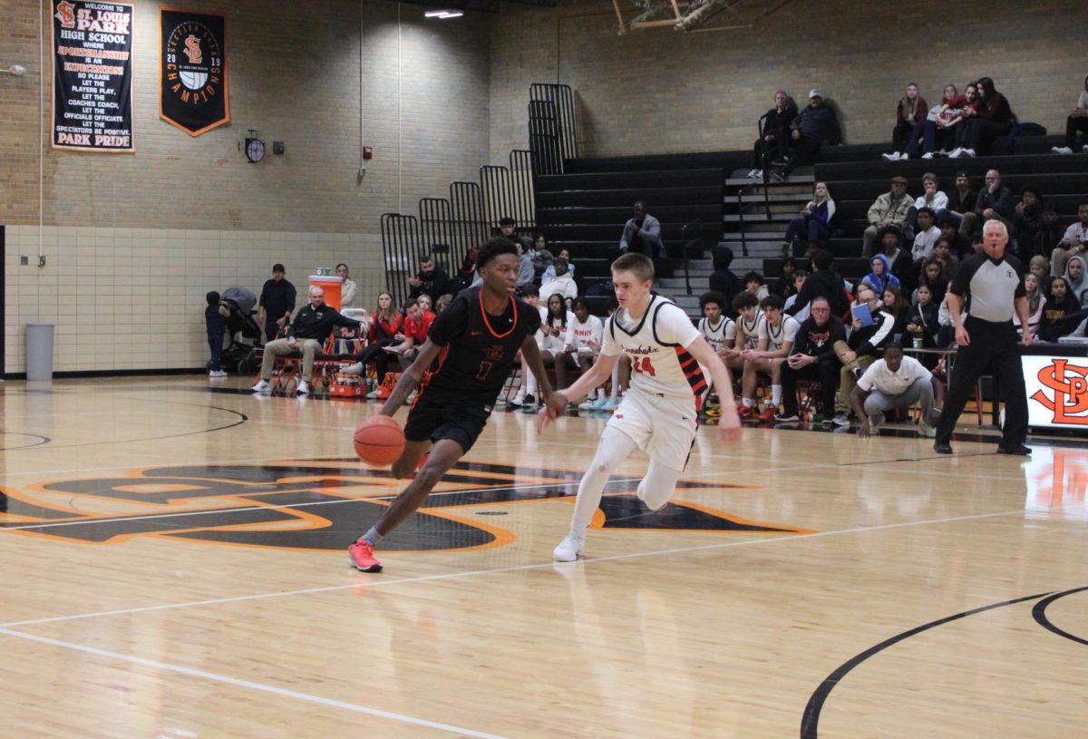 Junior Javaris Ellis dribbles the ball Dec. 15. Park boys basketball dominated with a final score of 102-82.