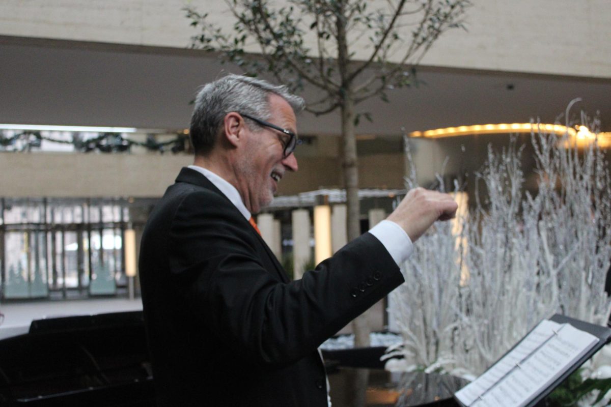 Choir teacher John Myszkowski conducts for Park Singers. Performance took place at the U.S. Bank Plaza on Dec. 11.