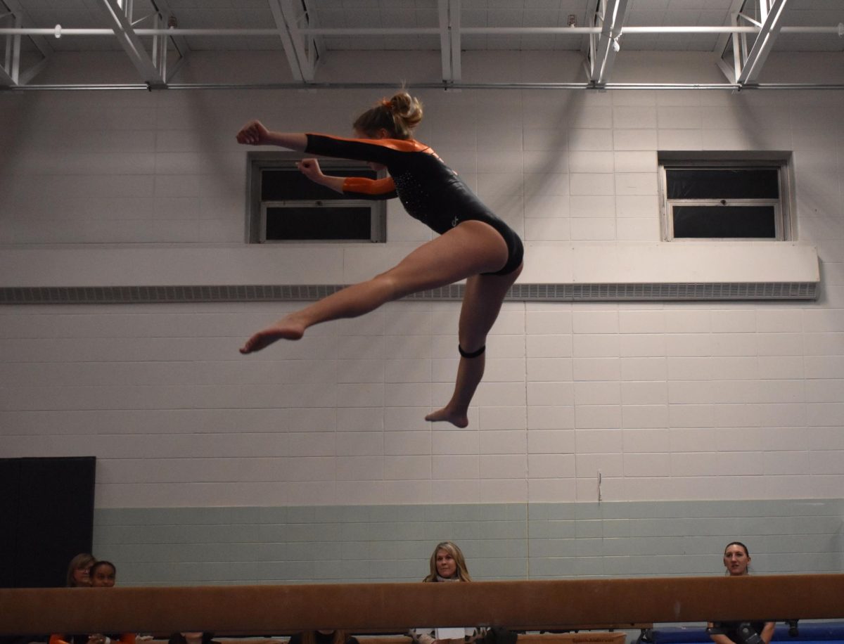 Sophomore Carly Otos performs her beam routine at a meet Jan. 23. Park’s gymnastics team received a season record for their performance in the meet. 