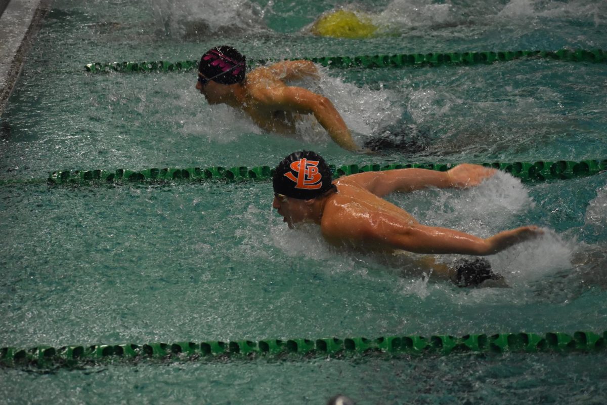 Middle-schooler Axel Smith swims neck-and-neck with an opponent Jan. 13. The boys team competed at the True Team meet on Saturday.