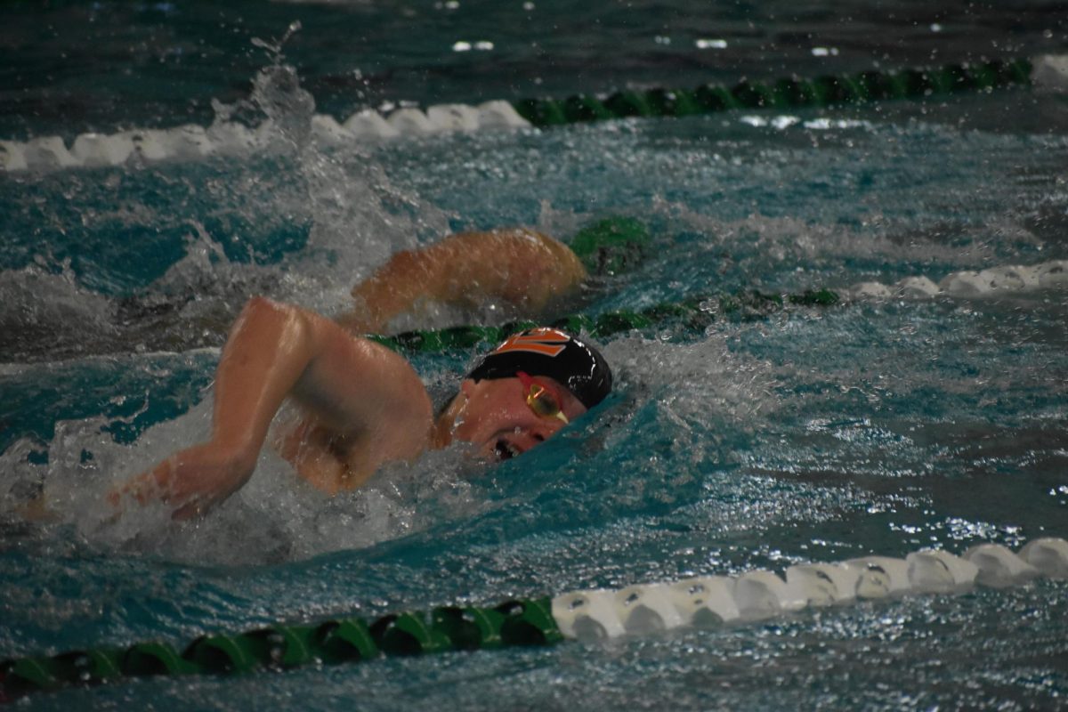 Junior Henry Berg swims the 500 freestyle on Jan. 13. Berg achieved a personal record on the 500 free, swimming it in under five minutes.