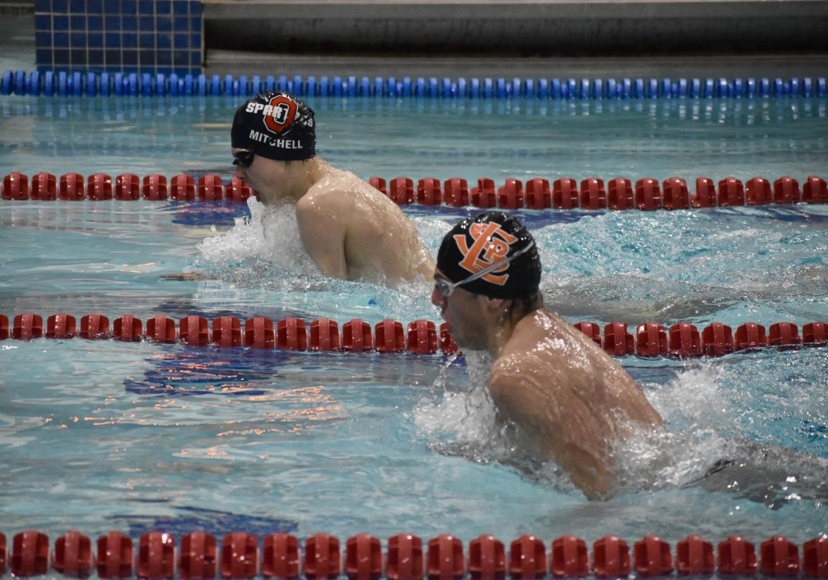 Senior Henry Salita swims in synch with Orono swimmer during the 500 breaststroke. Boys swimming lost 71-88 to Orono Jan. 25.