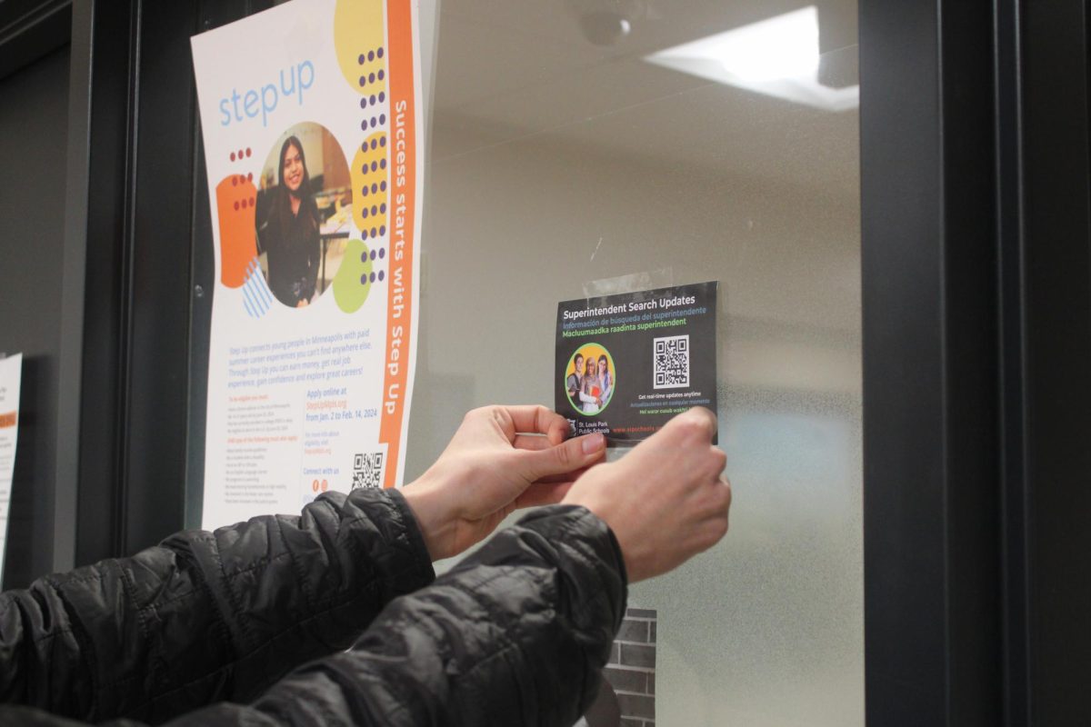 Park student tapes up new QR code Jan. 25. Park has been recently searching for a new superintendent. 