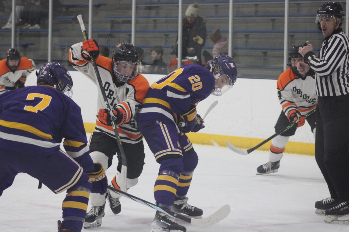 Senior Sam Fuller fights for the puck after the faceoff Jan. 18. Park beat Waconia 5-0.