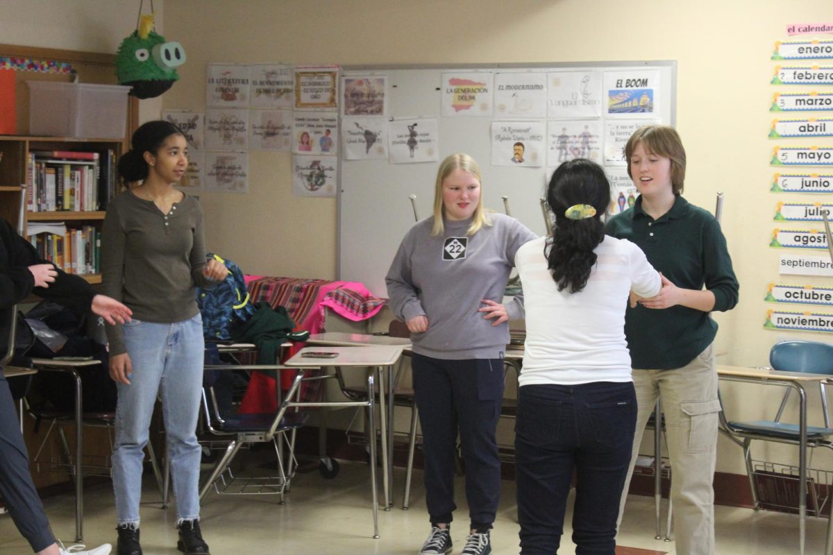Spanish teacher Hanna Anderson instructs students on how to dance merengue Jan. 18. Spanish club mets every third Thursday of the month.