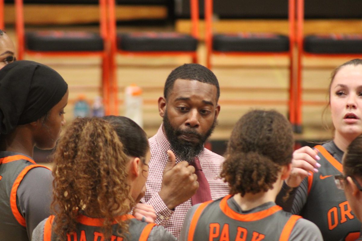 The girls basketball team’s new head coach Ron Howard talks to the players before the game Jan. 23. This is Park’s first season with Howard as head coach. 