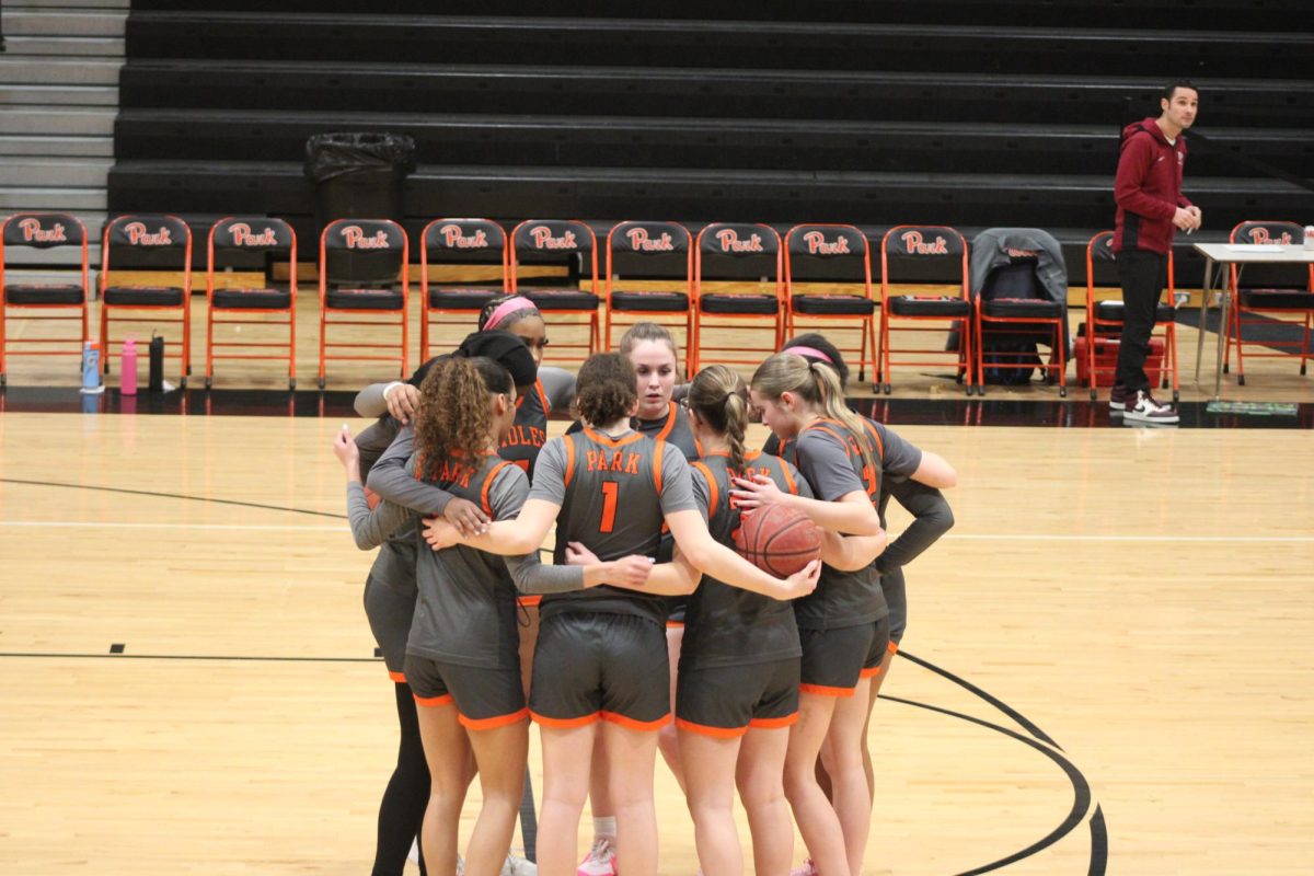Park’s girls basketball team huddles up to prepare for their game against New Prague. The game ended with a loss of 93-52 Jan. 23.