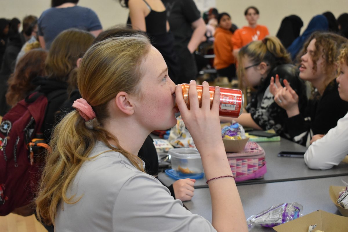 Sophomore Eleanor Cruz drinks an energy drink at lunch Feb. 22. Continual consumption of drinks with a high caffeine content can lead to negative health effects.