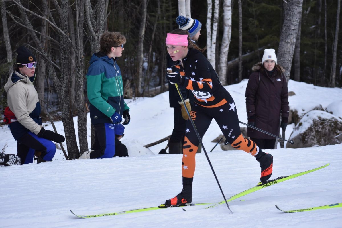 Senior Hanna Wilsey strides to the top of the hill during the girls classic-interval qualifier race on Feb 13. Wilsey finished in third, giving her a third-place start in the pursuit finals later that day.