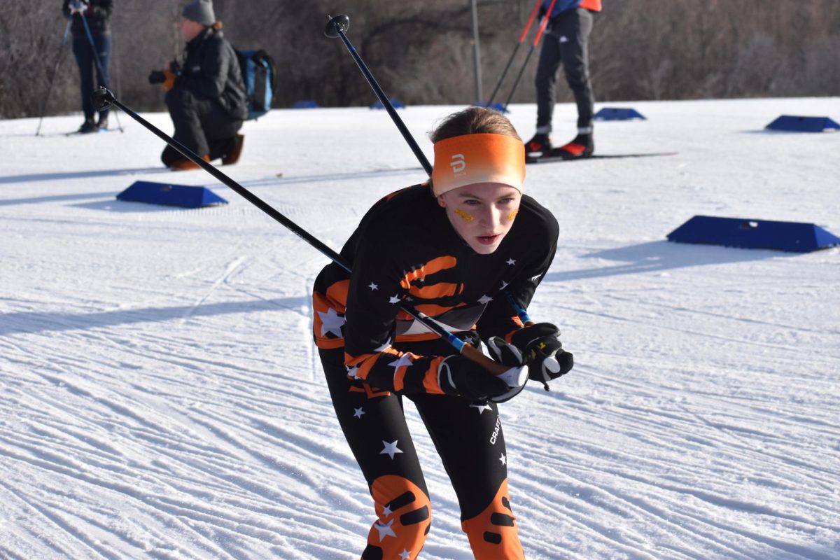 Eighth grader Adeline Stewart tucks in the final stretch of her classic race Feb. 5. Stewart finished in 12th, and she and the girls varsity team will be going to the state race on Feb. 14 and 15.