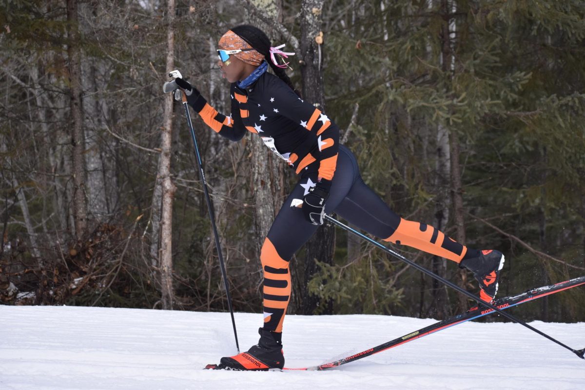 Senior Ayelel Meyen takes a big stride on a short flat section in the middle of a hill in the pursuit course on Feb 13. Meyen finished 50th in the pursuit race and in the state.
