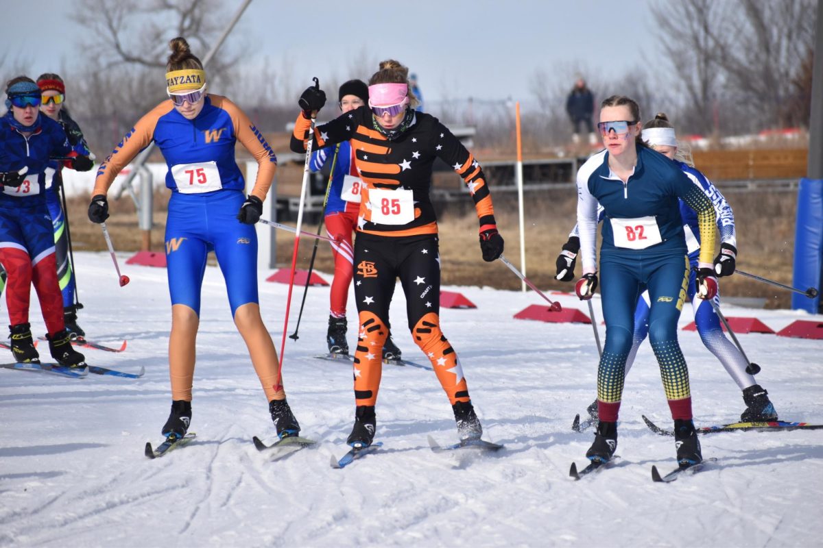 Senior Addison Chenvert gets squished in between the two classic tracks when starting her race Feb. 5. Chenvert skied the first and third legs for the classic relay.