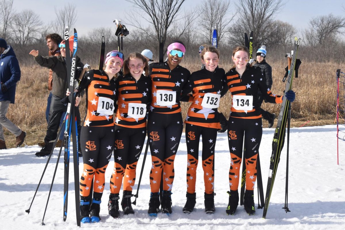 Seniors Hanna Wilsey, Jersey Miller, Ayelel Meyen, eighth-grader Adeline Stewart and junior Nora Lindeman pose for a picture after their pursuit skate race Feb. 5. They finished the race with all five skiers in the top 13.
