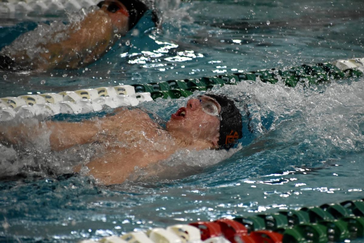 Senior Henry Salita swims the final stretch of the 100 back finals on Saturday. Salita placed fourth in the sections event on Feb. 24.