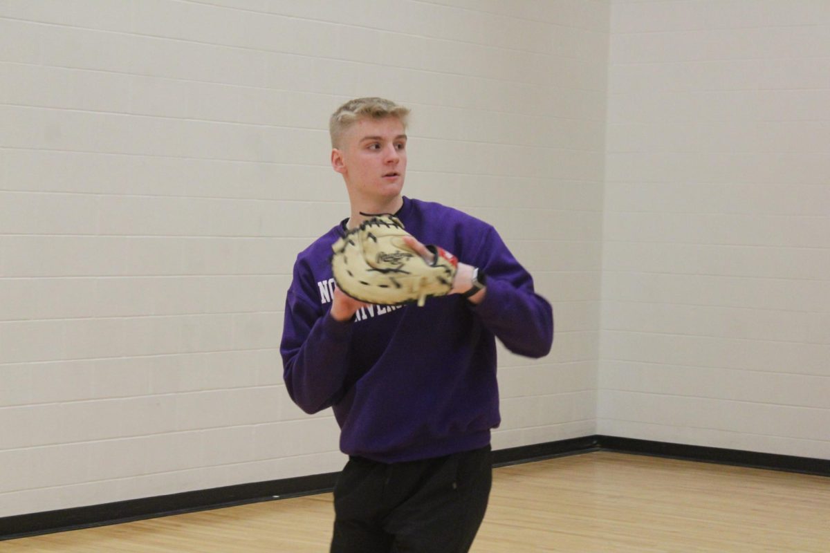 Senior Zach Navenski prepares to throw a ball Feb. 7. Baseball began captains practices this week.