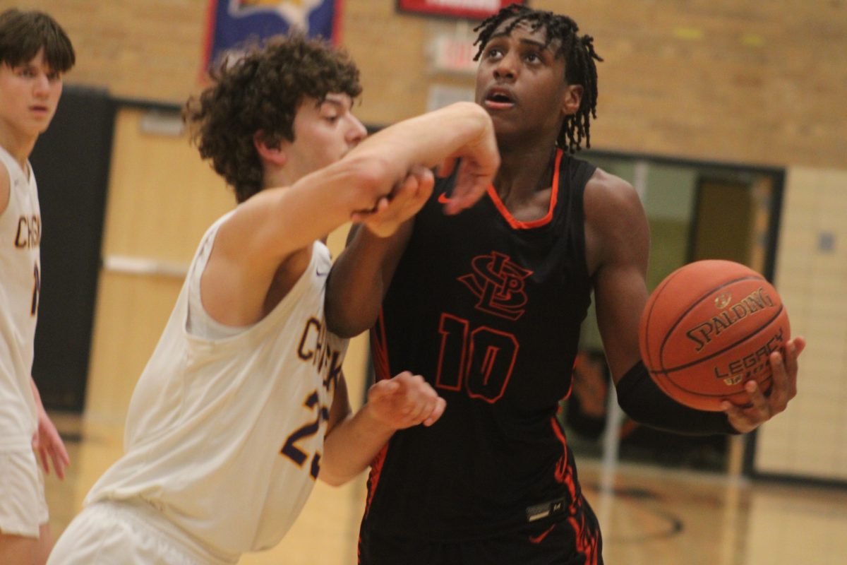Junior Micah Curtis slithers through a defender Feb. 9. Park defeated Chaska 92-72.