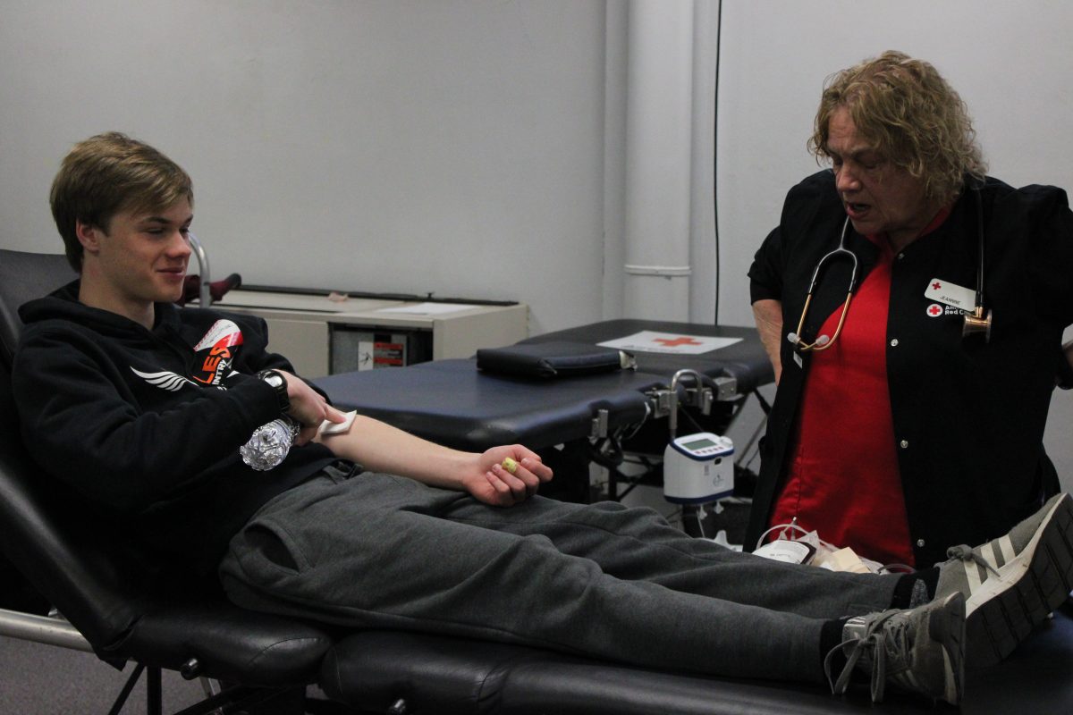Senior Johnny Erdmann participates in the Valentines Day blood drive Feb 8. Erdmann is going over the after care for drawing blood with his nurse.