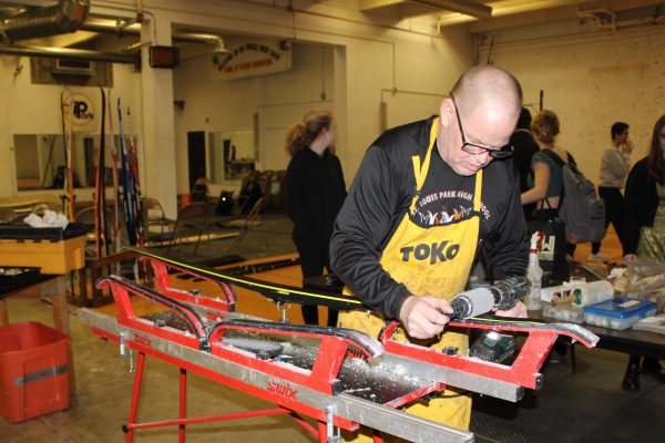 Nordic coach, Doug Peterson waxes a ski on Feb 1. The team uses the basement space as their headquarters and to do ski maintenance.