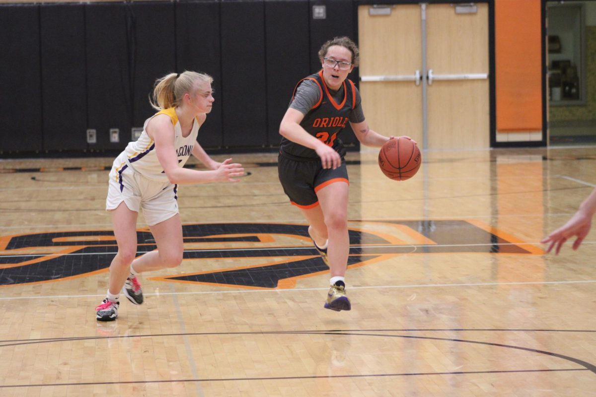 Senior+Evie+Schmitz+drives+towards+the+basket+Feb.+6.+Schmitz+manages+to+score+a+total+of+40+points%2C+contributing+to+a+90-81+win+against+Waconia.