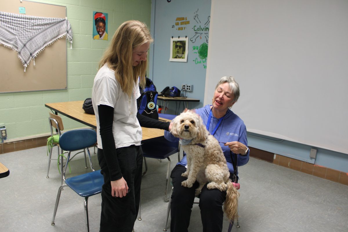 Sophomore Tess Machalek visits a therapy dog March 19. The therapy dogs work to help students navigate their stressful lifestyles.
