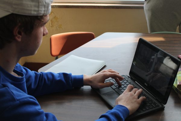 Junior Sam Tolzin works on his PSEO work Mar. 8. Tolzin is currently taking one online class this semester.