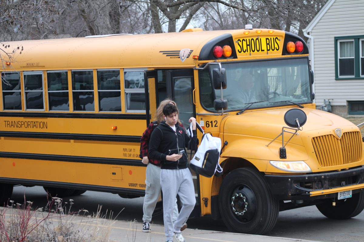 Newly enrolled junior Adam Kamel gets off the bus ready to start his day March 5. Park gives newly enrolled students free transportation to get to and from school every day.