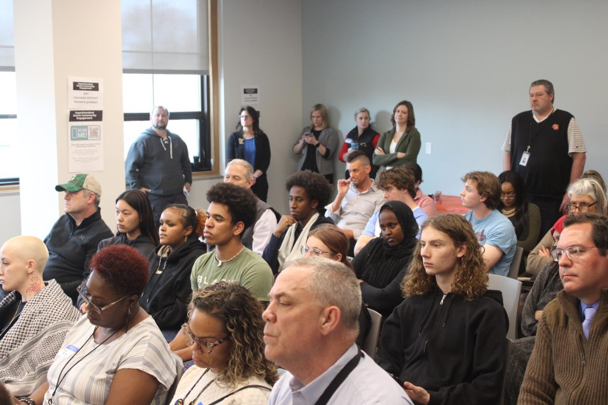 Park students from S.O.A.R. sit and listen among Park school staff and other community members at the school board meeting on Wednesday. The meeting on March 13. consisted of interviewing finalists for the St. Louis Park district superintendent position.