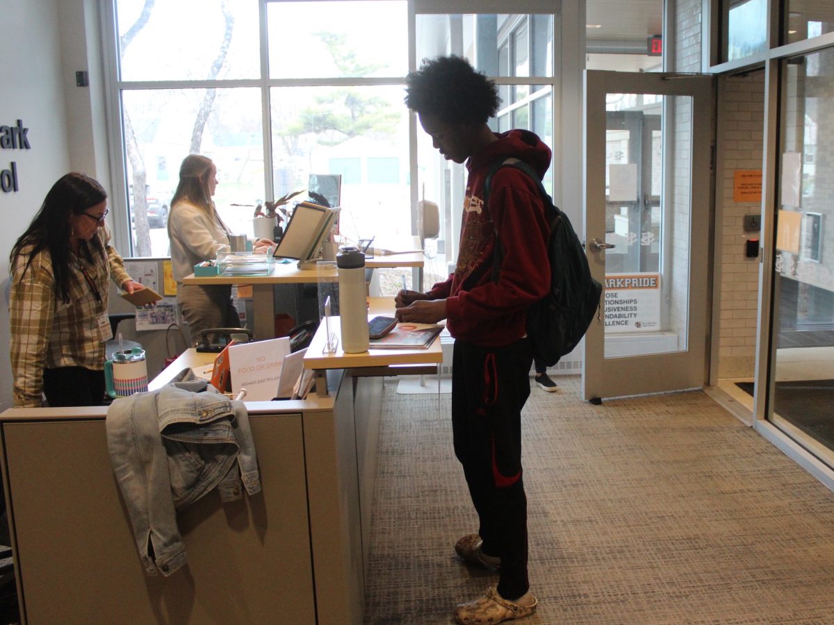 Student fills out late pass April 12. Students who arrive late must fill out a pass in order to go to class.