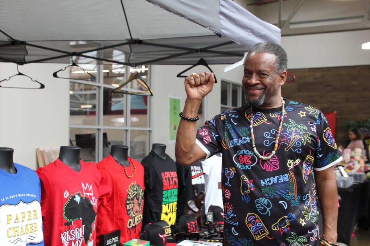 A+stall+owner+at+the+Black+Market+sells+black+pride+merchandise+on+April+13.+The+market+was+created+to+empower+the+Black+community.