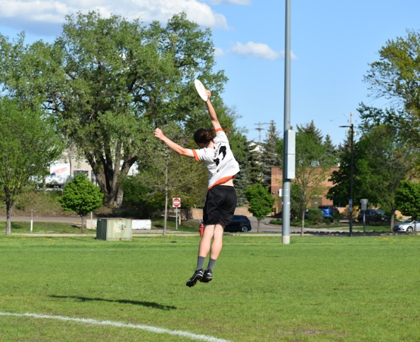 Senior Aaron Casey-Fix jumps to catch the frisbee on May 8. Parks boys ultimate team has been putting in the work to prepare for nationals.