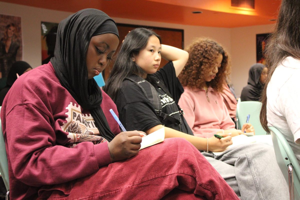 Junior Anisa Kahin writes in a journal May 23. Students were asked to reflect after being asked questions by SOAR facilitators.