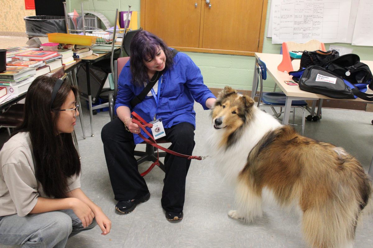 Sophomore Chonzom Alatsang relieves stress by visiting therapy dogs May 21. As finals approach Park students can stop by and see the therapy dogs as an outlet of their stress.