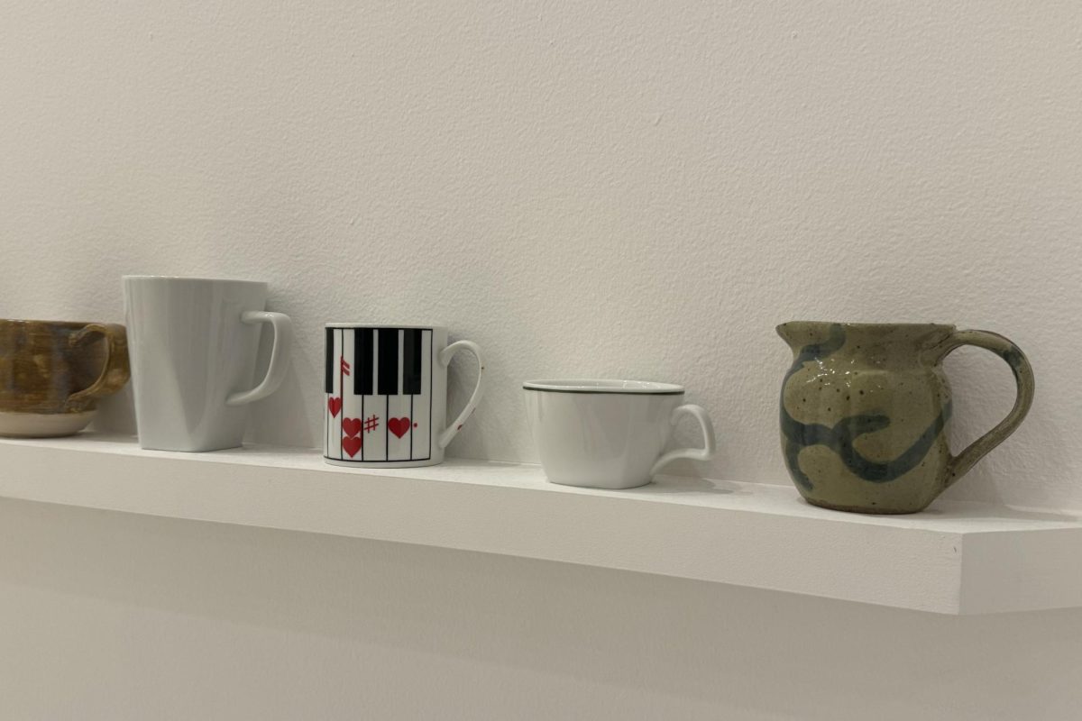 Display of a variety of mugs, hand sculpted at the Walker Art Center May 24. The shelf has many different shapes, sizes, glasses, and handles.
