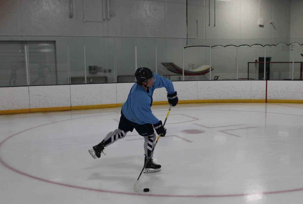 Senior Griffin Krone shoots a puck May. 7. Krone will be playing junior hockey in the fall.
