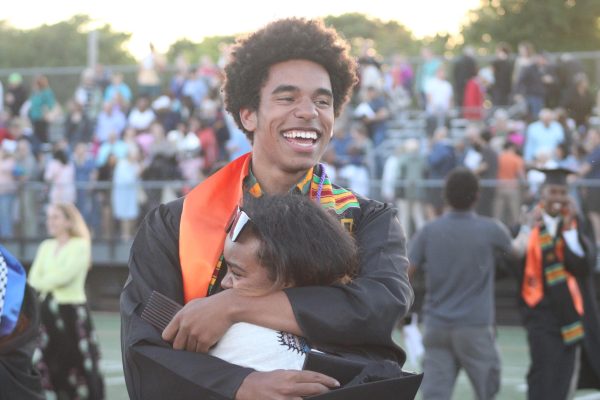 Senior Calvin Zimmermam embraces a family member at Park’s graduation June 5.  Zimmerman graduated at Park’s stadium with the class of 2024.
