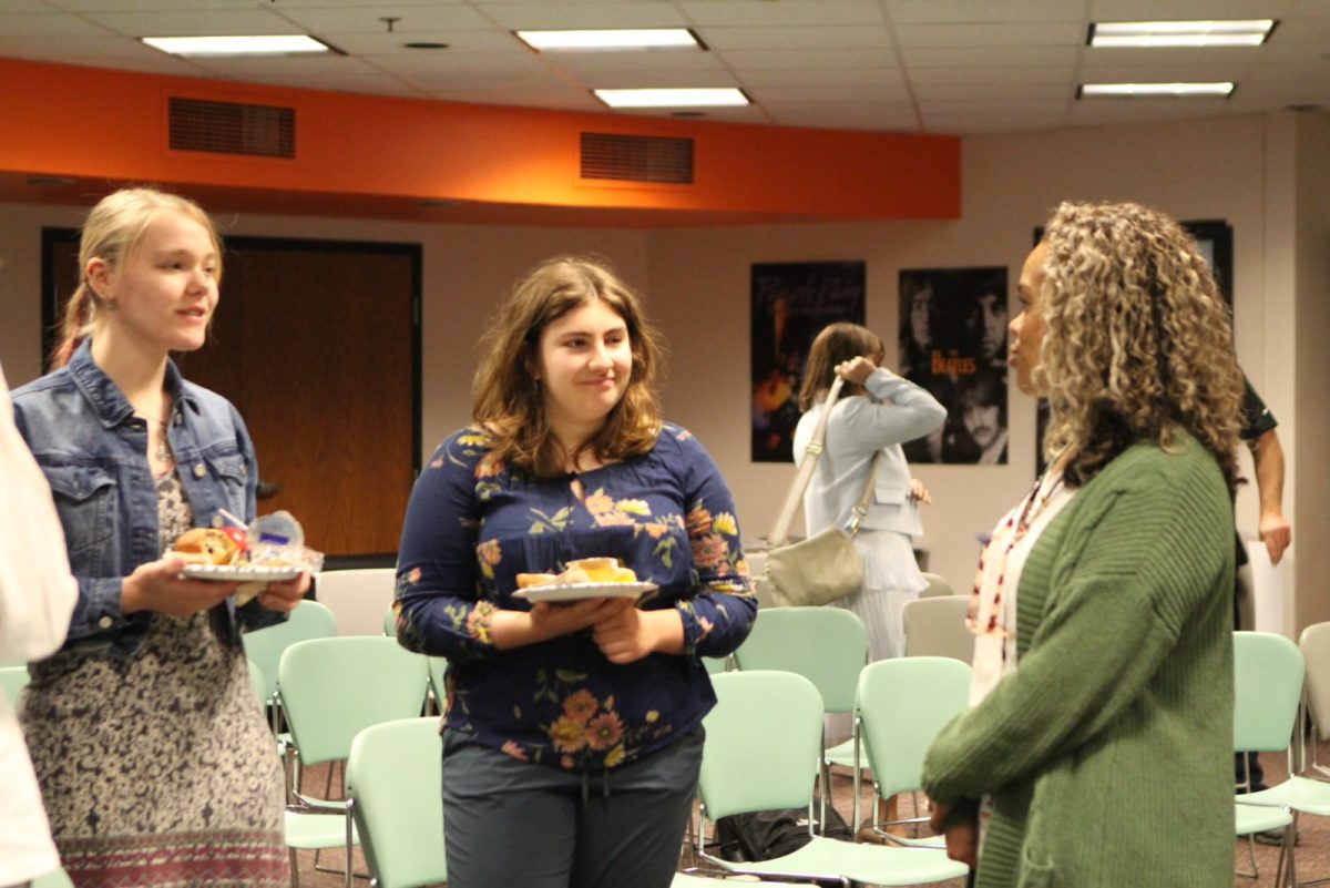 Seniors Elena Colacci and Johanna Halverson speak to Principal Paddock May 22. Seniors with a GPA of 4.0 and IB Diploma candidates spent the morning celebrating their accomplishments.