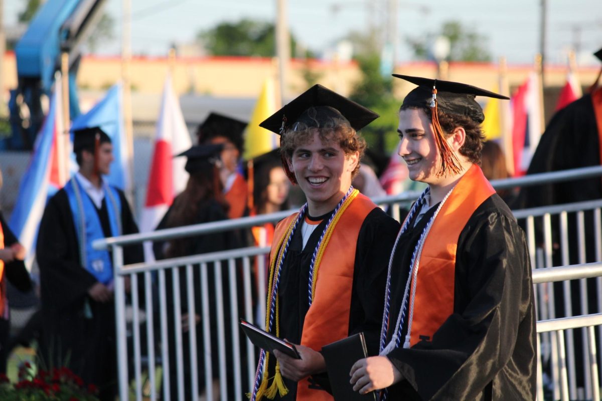 Seniors Henry Salita and Oliver Salita walk off the stage after receiving their diplomas June 5.  Henry Salita will be attending University of Wisconsin Madison in the fall and Oliver Salita will be attending University of North Dakota.