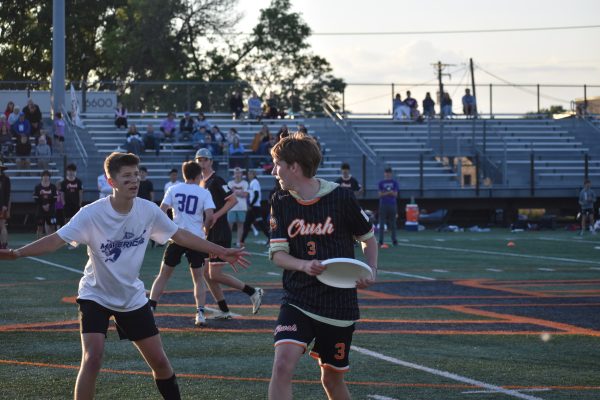 Senior Parker Knudson looks to make a pass to a teammate May 22. Orange Crush Ultimate was triumphant against Andover, winning 12-11.